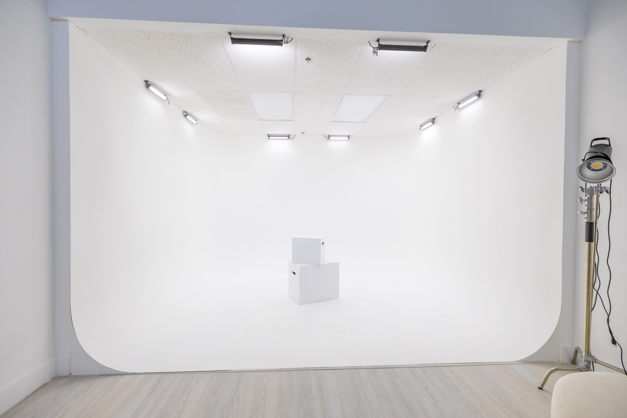 The pre-lit white cyclorama wall with overhead light panels
